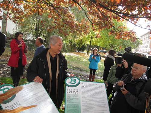 Wayson Choy with the 'Jade Peony' Bookmarks (Chinese on the left, English on the right)